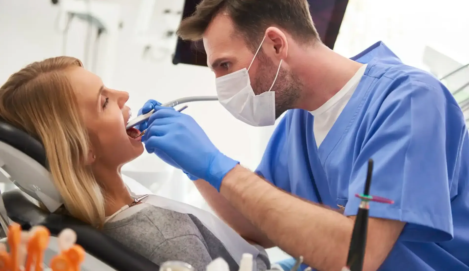 focused-stomatologist-using-dental-drill-and-dental-mirror copy